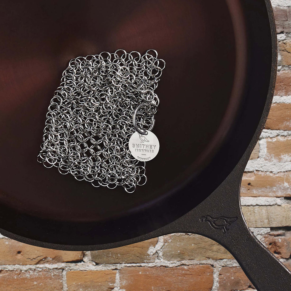 View of Smithey Ironware 5x5 Stainless Steel Chainmail Scrubber for cleaning cast iron cookware