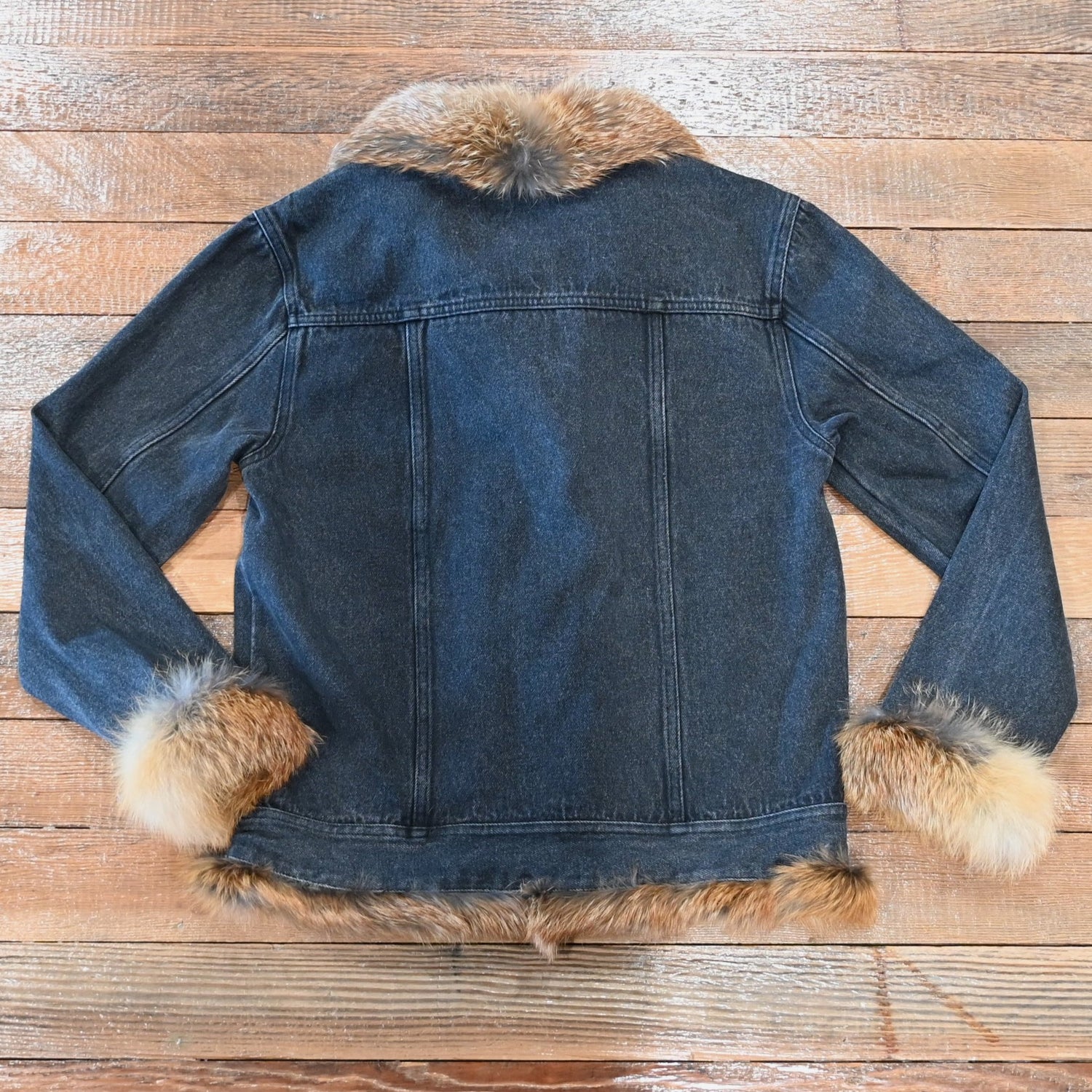 Black denim jacket with red fox fur trim on collar, cuffs, and front placket
