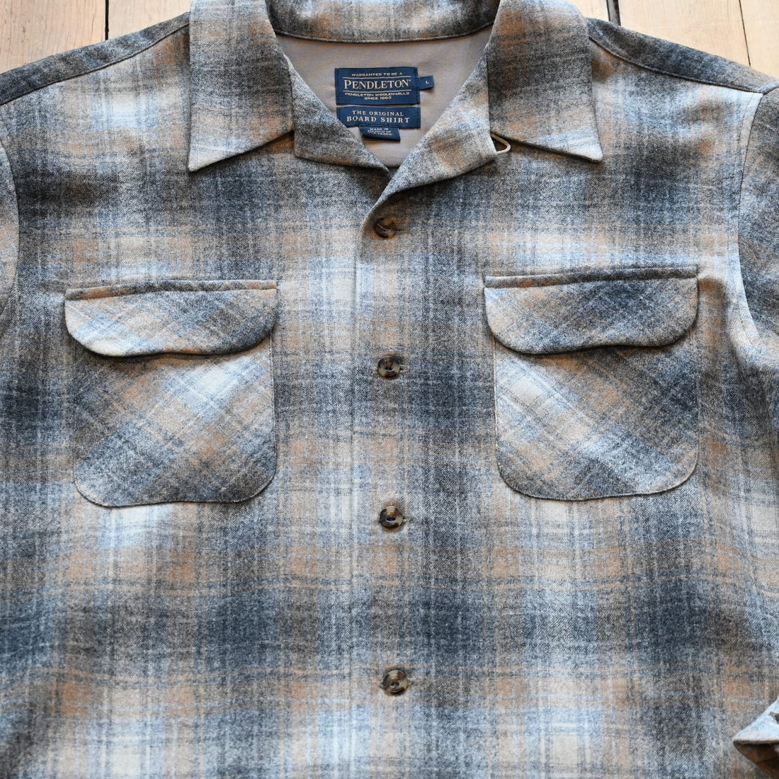 View of Pendleton men’s wool board shirt in grey and tan mix plaid with square hem and bias chest pockets