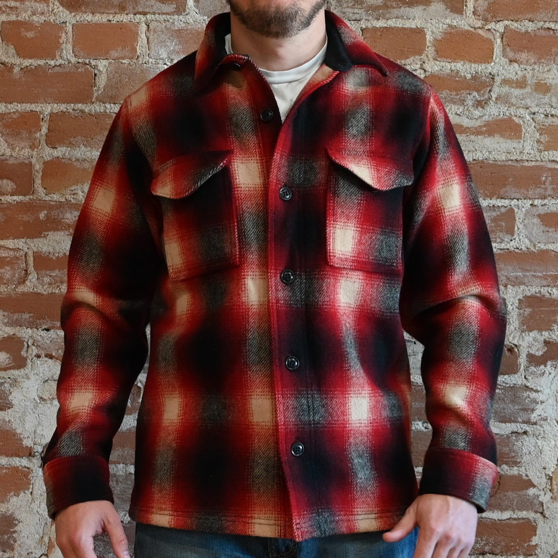 View of Filson Mackinaw Wool Jac-Shirt in Black Coffee Multi Plaid and Red/Black Ombre Plaid featuring button-front closure, adjustable cuffs, and hidden button-secured pockets