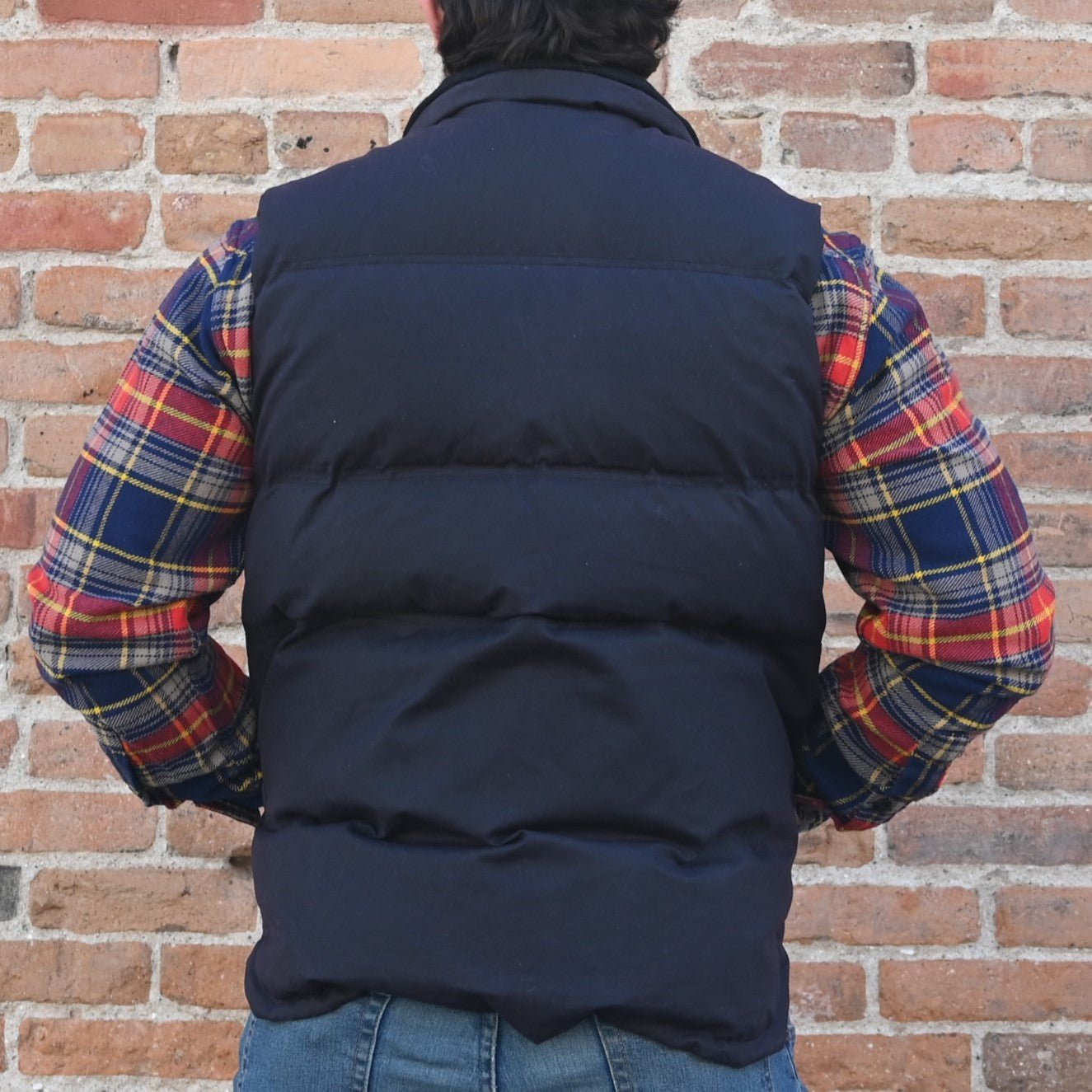 View of back of vest in blue coal