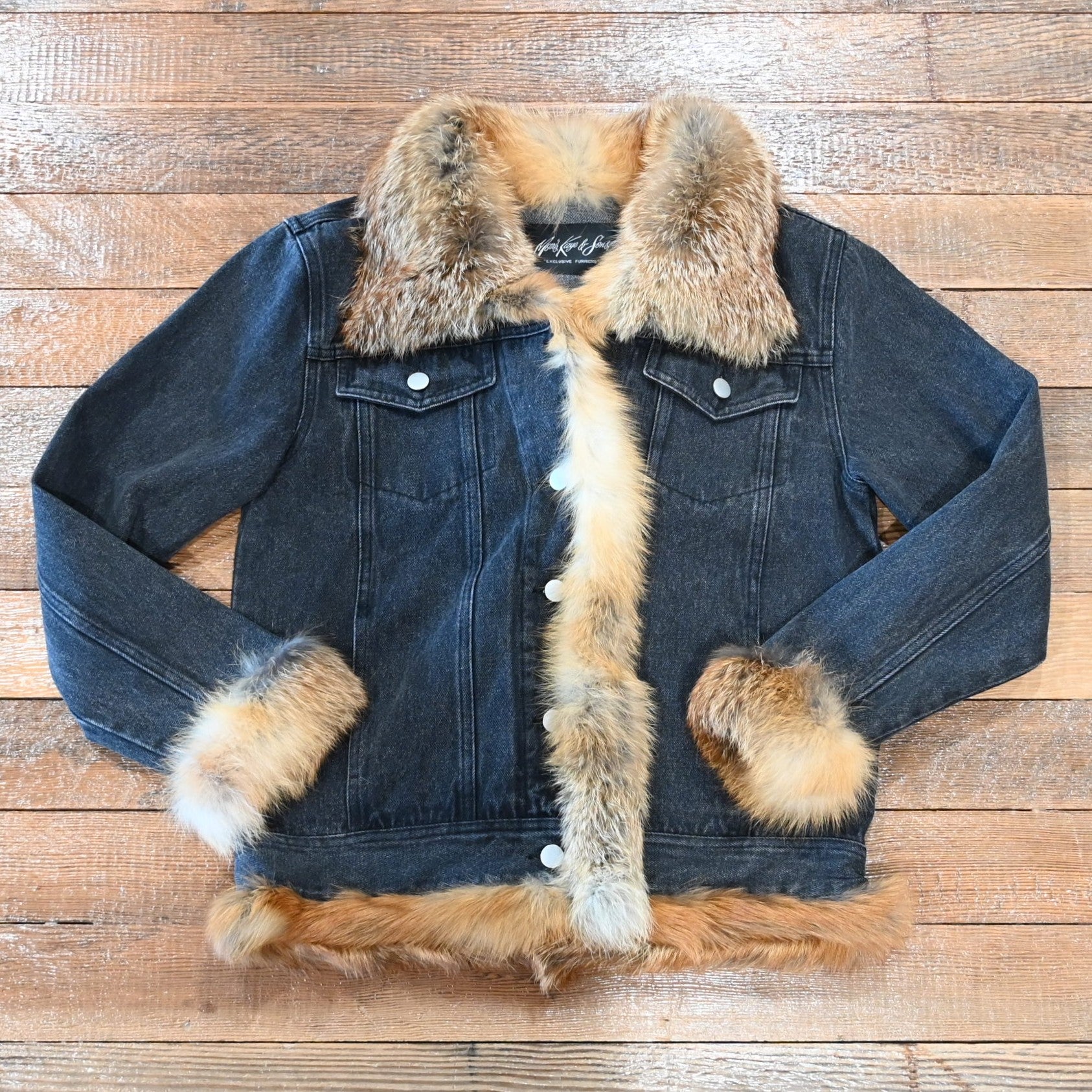 Black denim jacket with red fox fur trim on collar, cuffs, and front placket