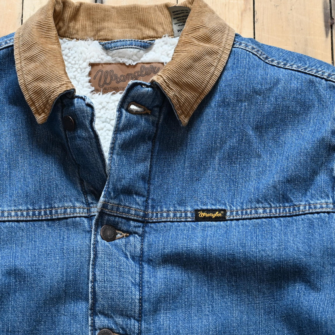 View of Wrangler sherpa-lined denim jacket in Antique Indigo with vintage wash and straight yoke