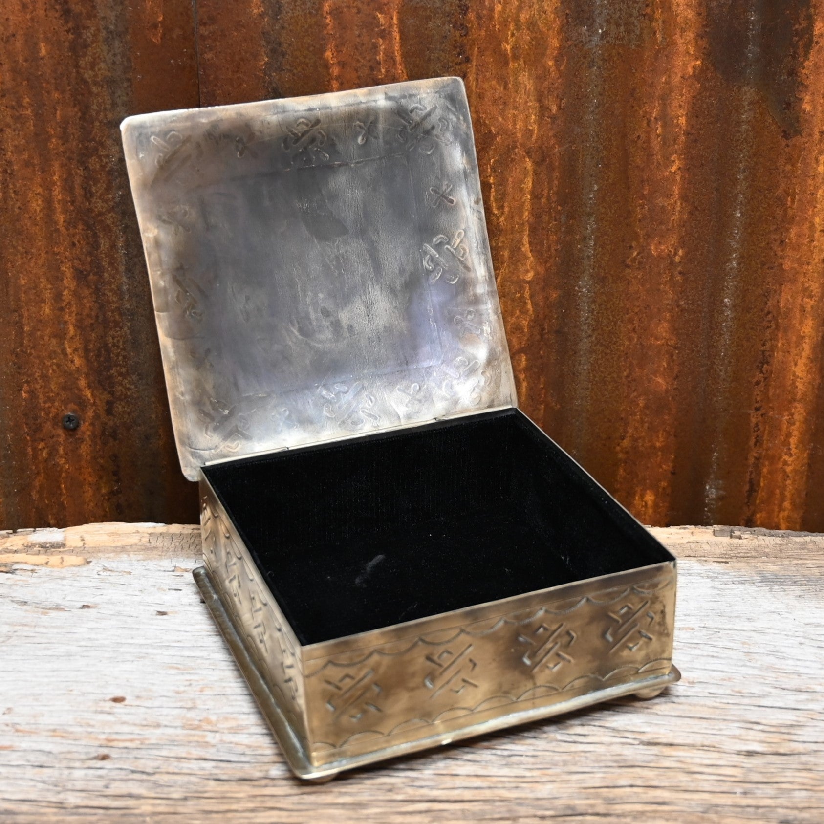 View of stamped silver box with bronco 