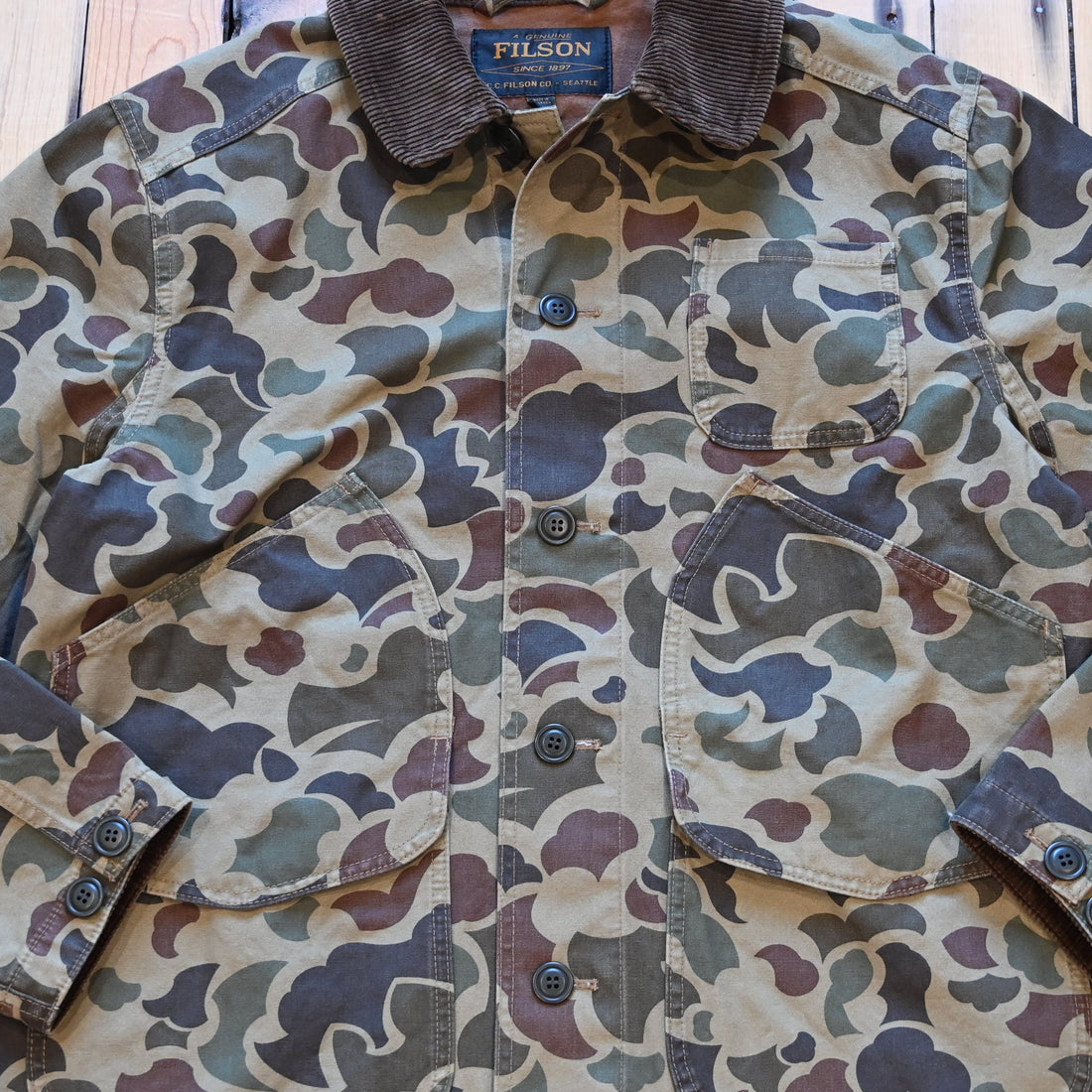 Filson Canvas Outfitter Jacket in shrub camo with dark brown corduroy collar and cargo-style pockets