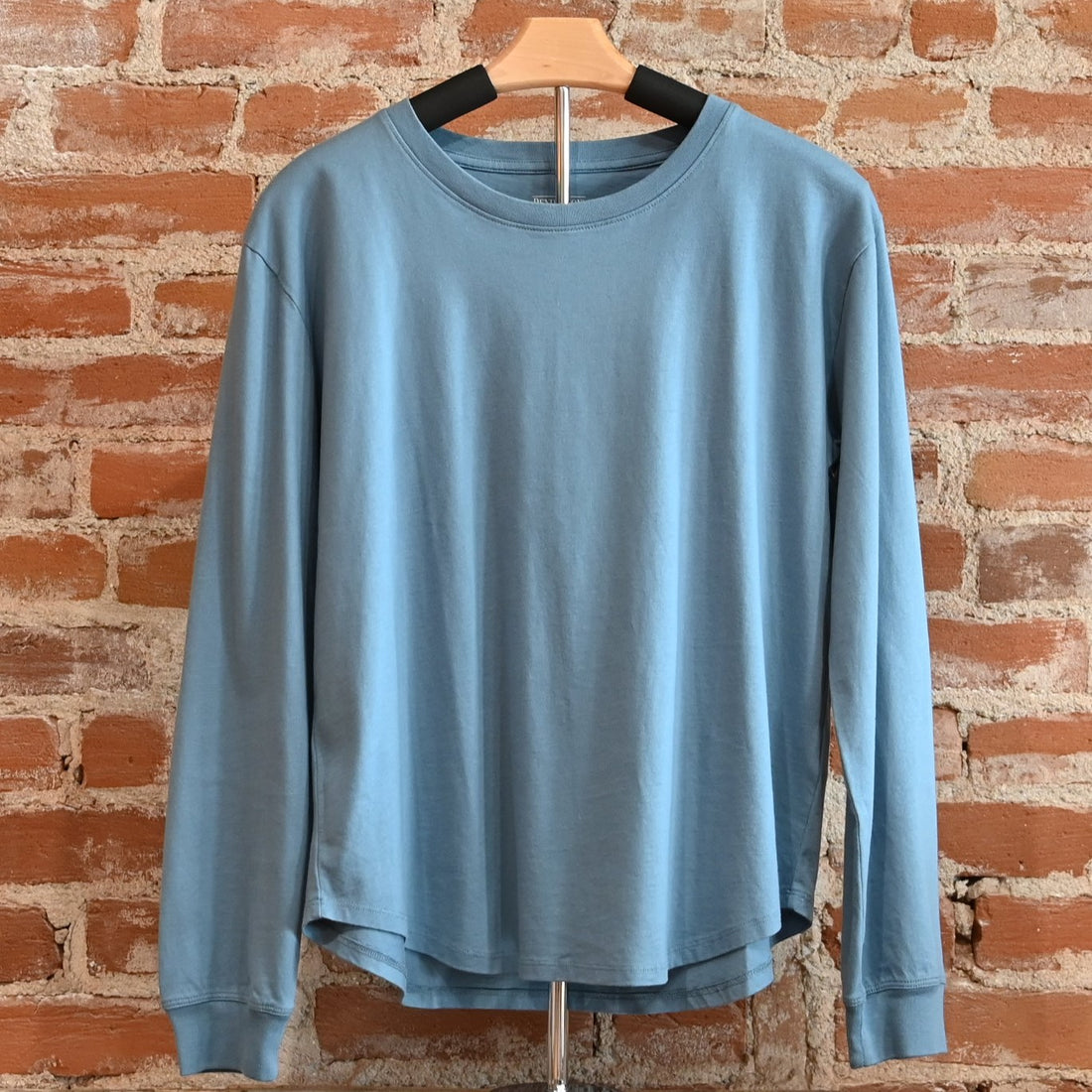 View of Pendleton long sleeve Deschutes Tee in Bay Blue and Cabernet with curved hem