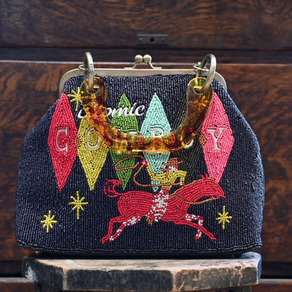View of Beaded handbag in Atomic Ranch colors with tortoise shell lucite handle