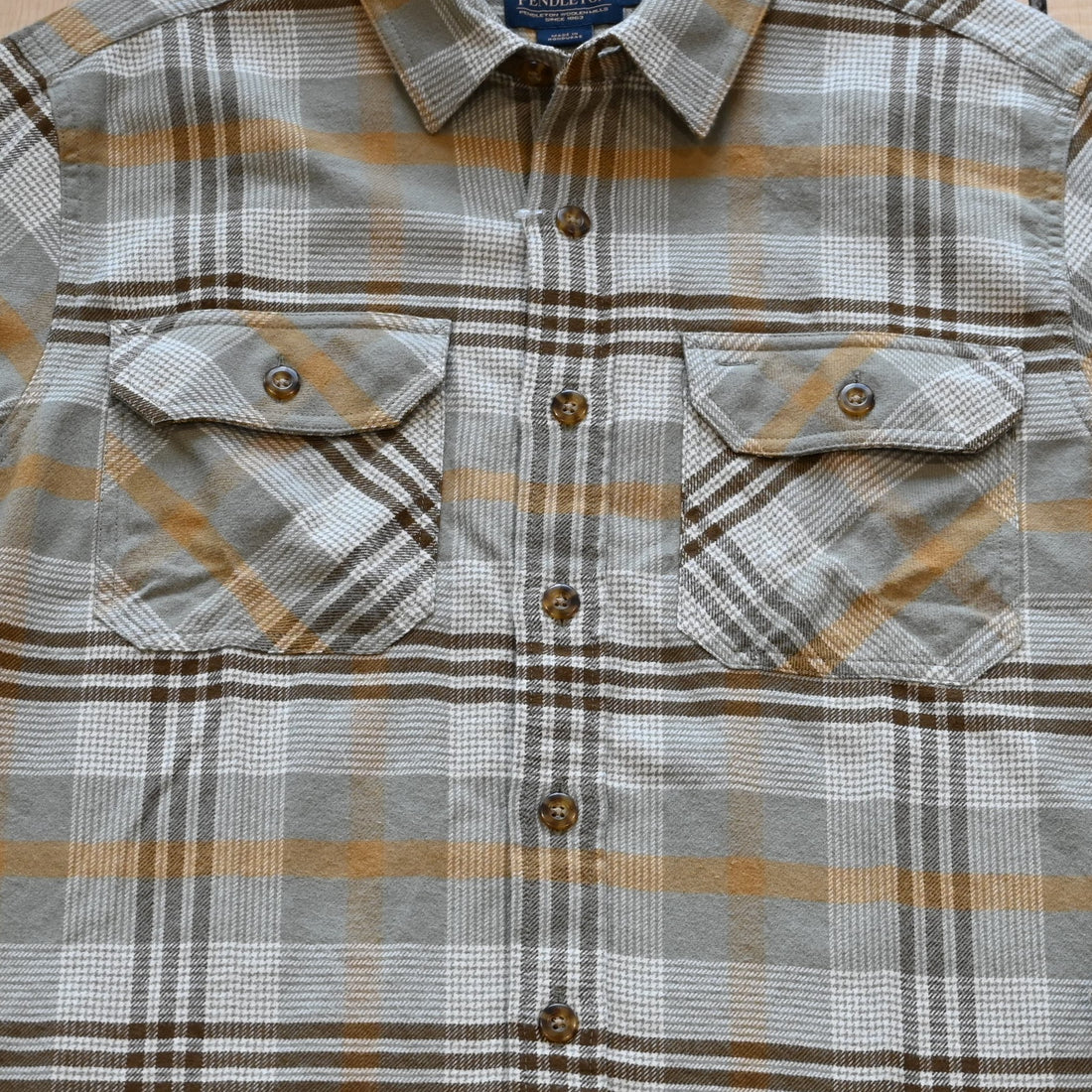 View of Plaid button-up shirt in tan, brown and grey by Pendleton Burnside style