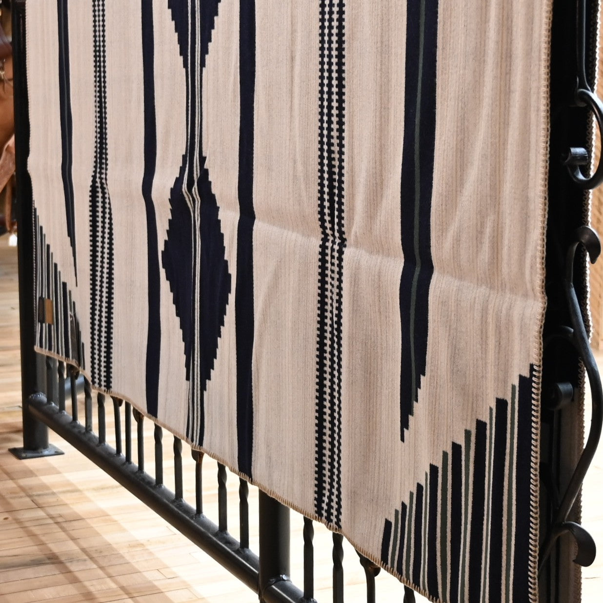 View of Pendleton robe-size blanket in navy and white jacquard wool blend