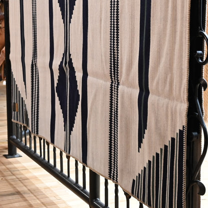 View of Pendleton robe-size blanket in navy and white jacquard wool blend