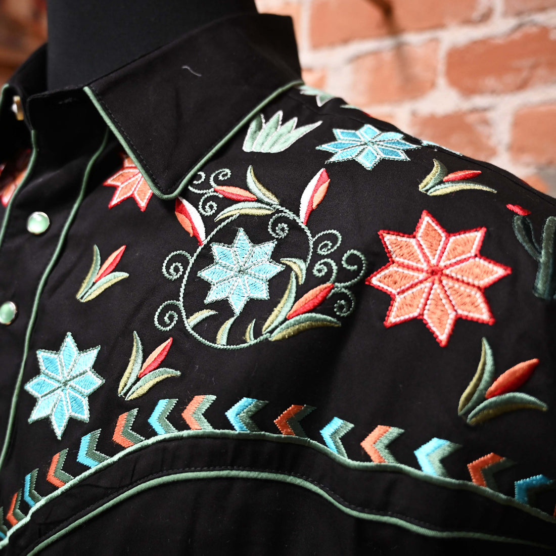 View of Black western shirt with embroidered floral, agave, and cactus motifs and Western piping