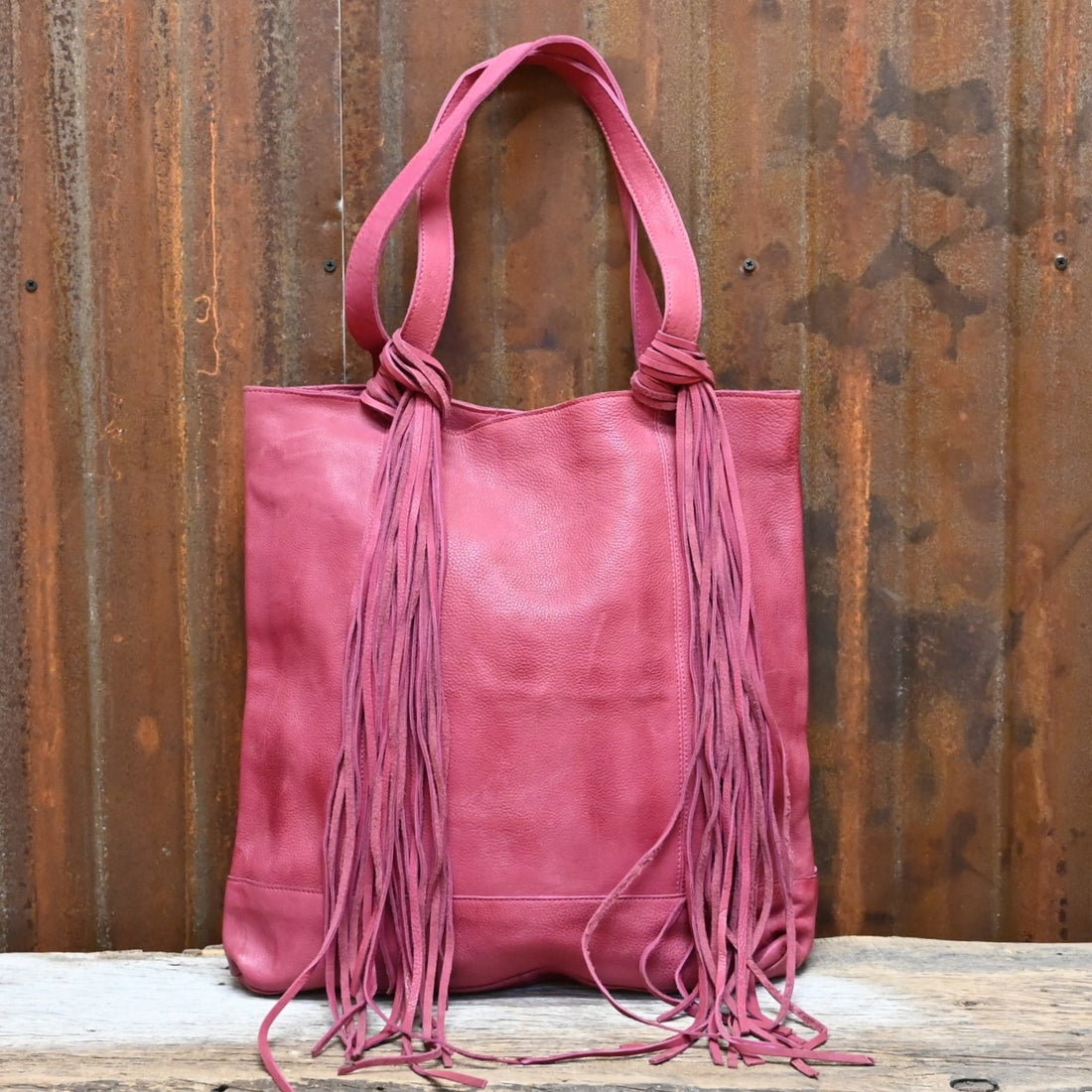 American Darling Leather Shoulder Bag with Fringe Details in Fuchsia view of front