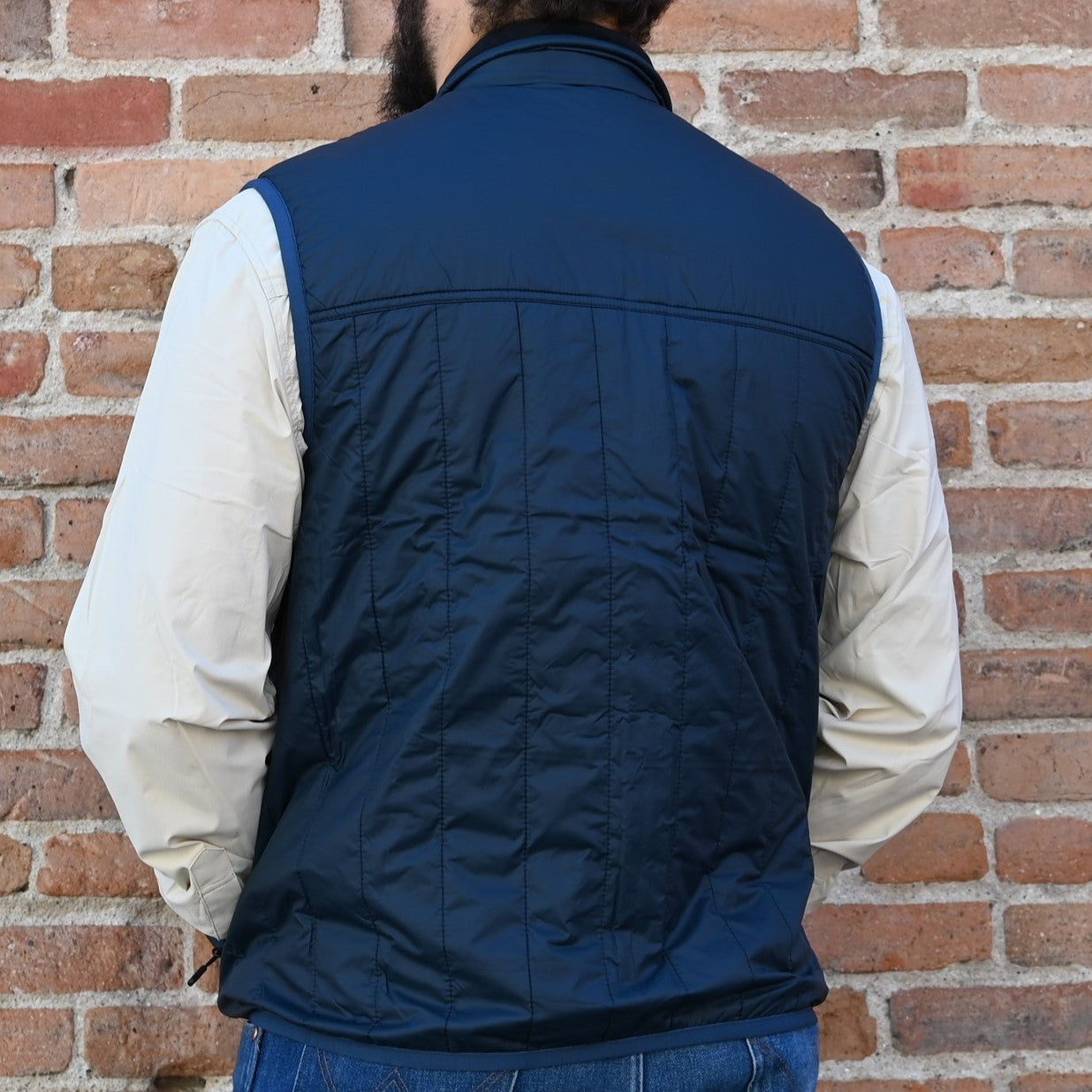 View of back of vest in coal blue