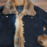 Black denim jacket with red fox fur trim on collar, cuffs, and front placket