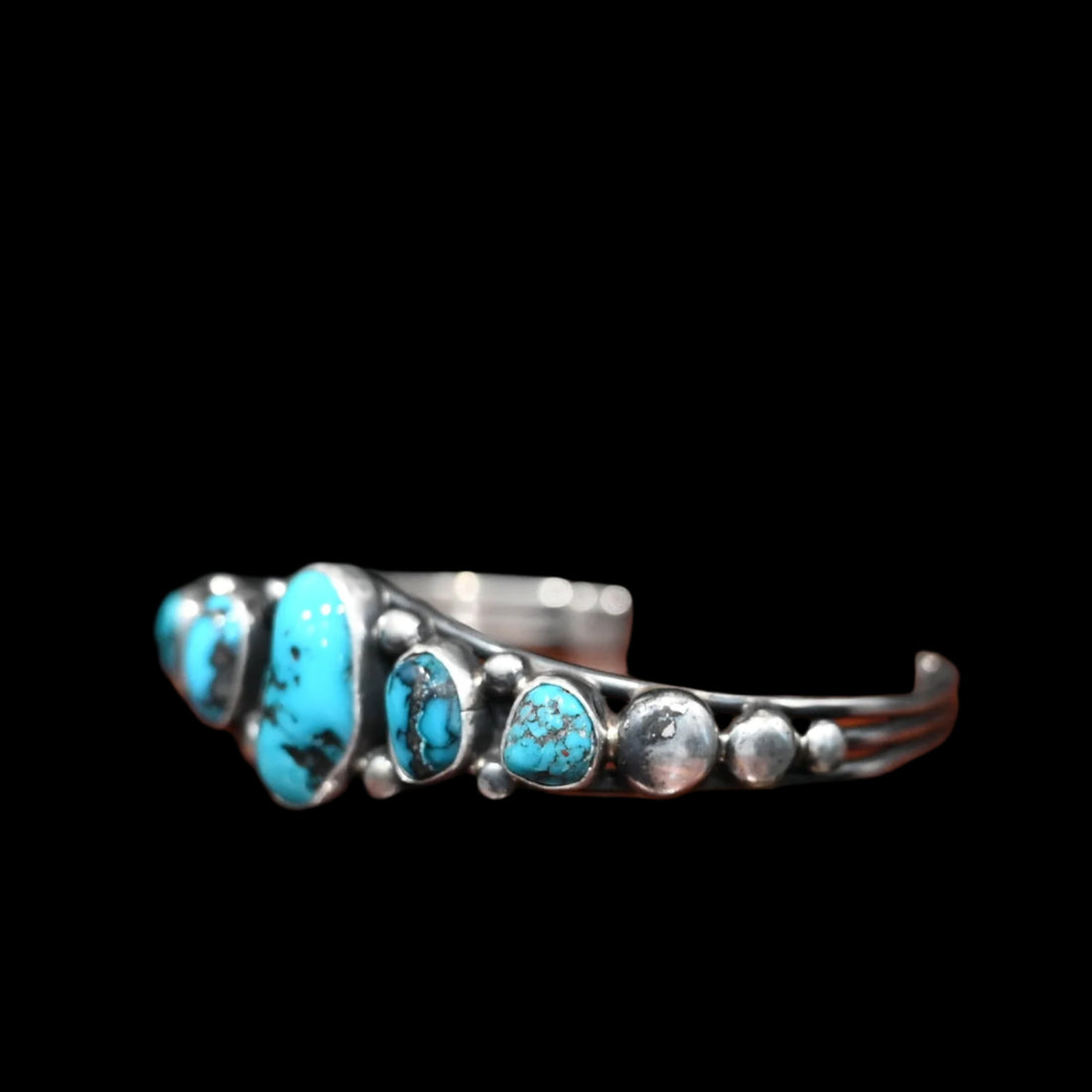 View of Sunwest Silver Kingman Turquoise Cuff featuring five Kingman turquoise stones, with the largest at the center, set in sterling silver