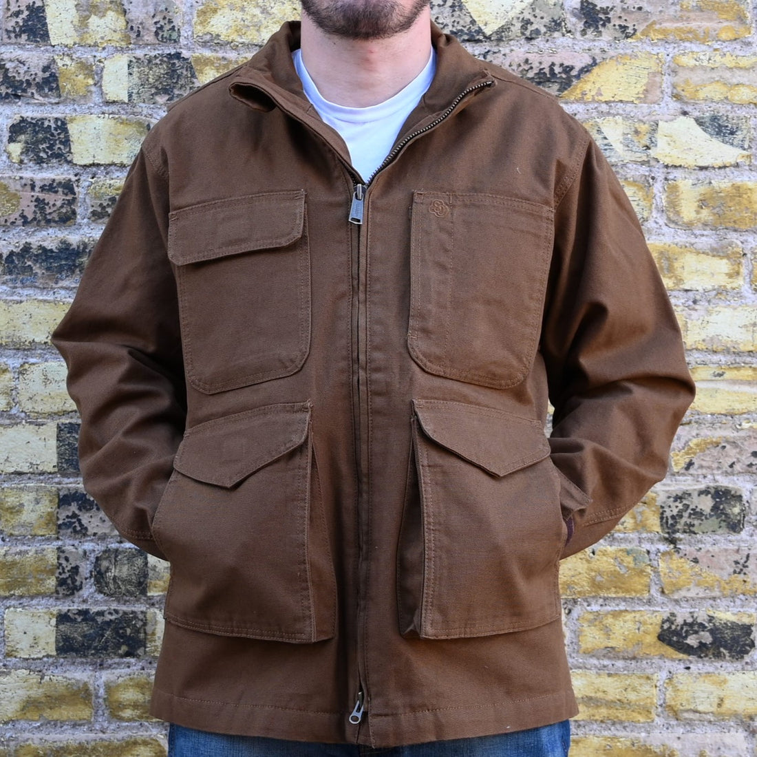View of Schaefer tobacco-colored canvas ranch jacket with quilted liner, snap-out ride vents, and multiple utility pockets