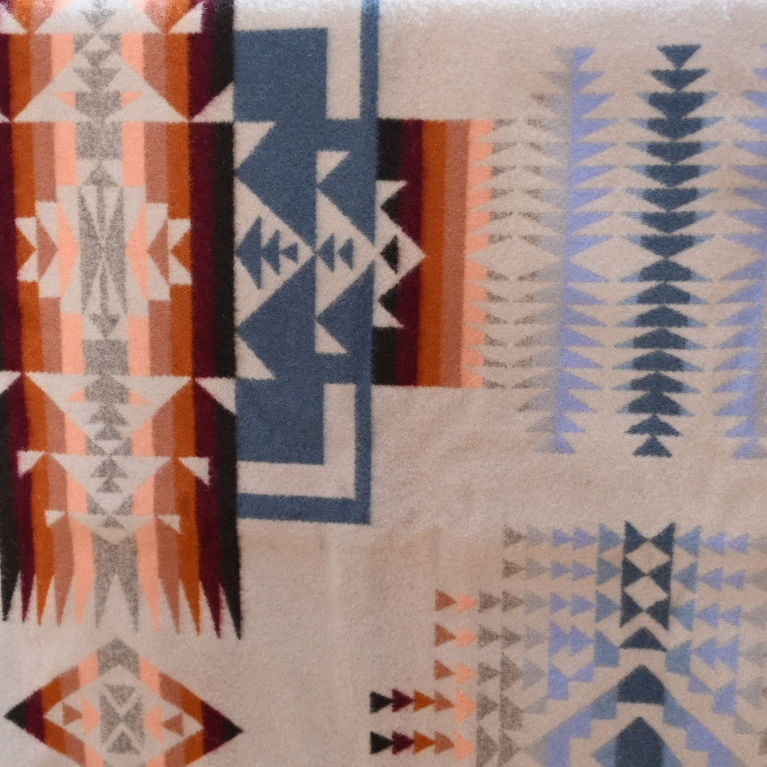 View of Pendleton Chief Joseph Rosewood queen blanket in soft blue, cream, and pink tones