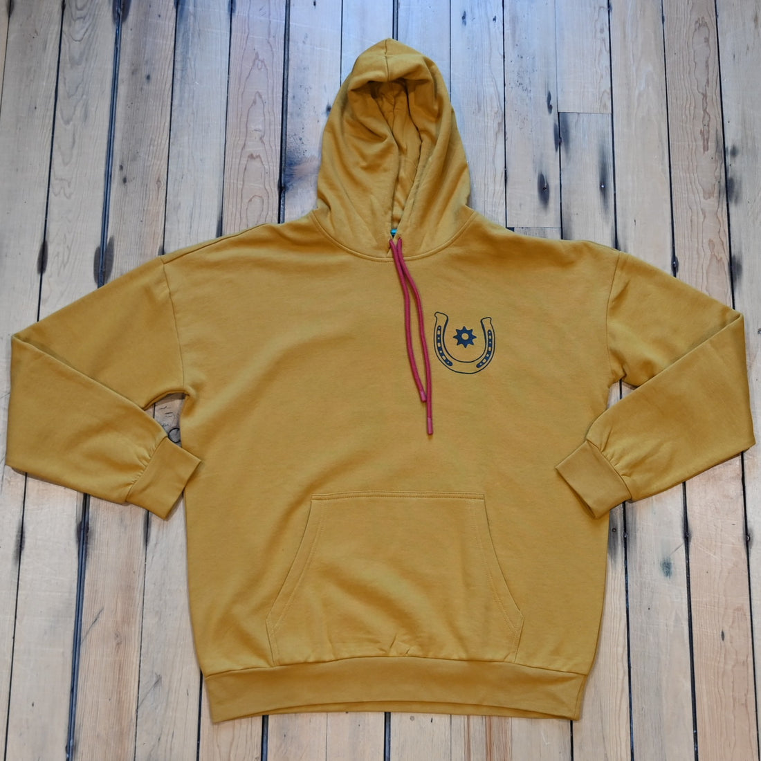 Goldenrod Sendero No Luck hoodie with horseshoe graphic and Sendero Provisions logo