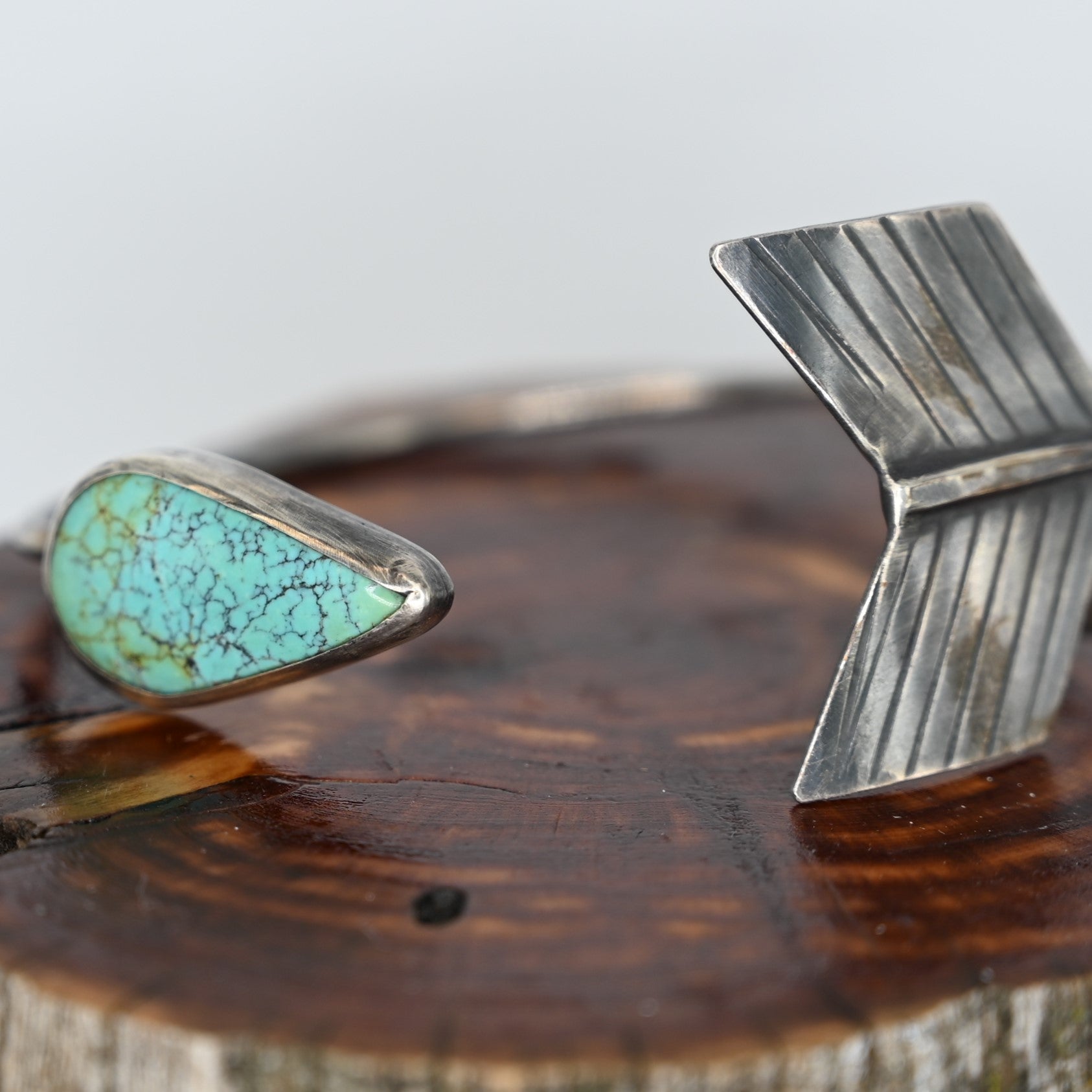 Discover the perfect blend of style and symbolism with our Arrows Cuff featuring authentic Turquoise. Handcrafted by Union Studio Metals, this cuff represents unity and strength, making it a meaningful accessory for any outfit. view of detail