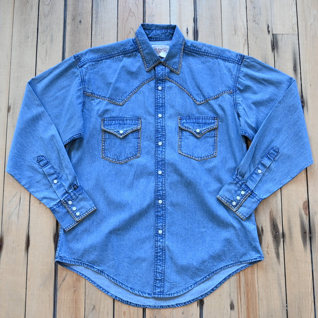 View of Rockmount men’s stonewashed denim Western shirt with blanket stitch detailing and snap front