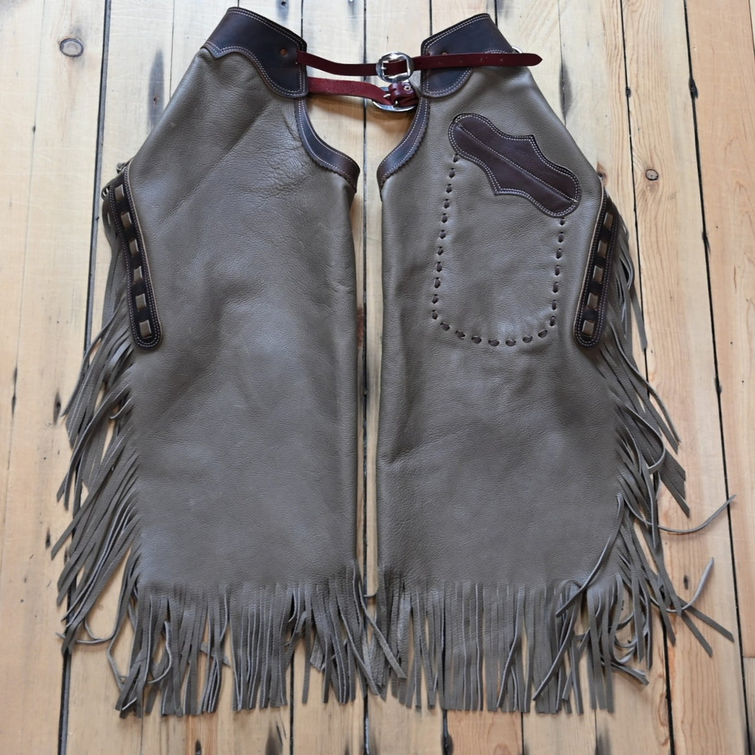 View of Rockin’ Y Saddlery Adult Arizona Chinks with fringe and buckle front in assorted sizes and colors