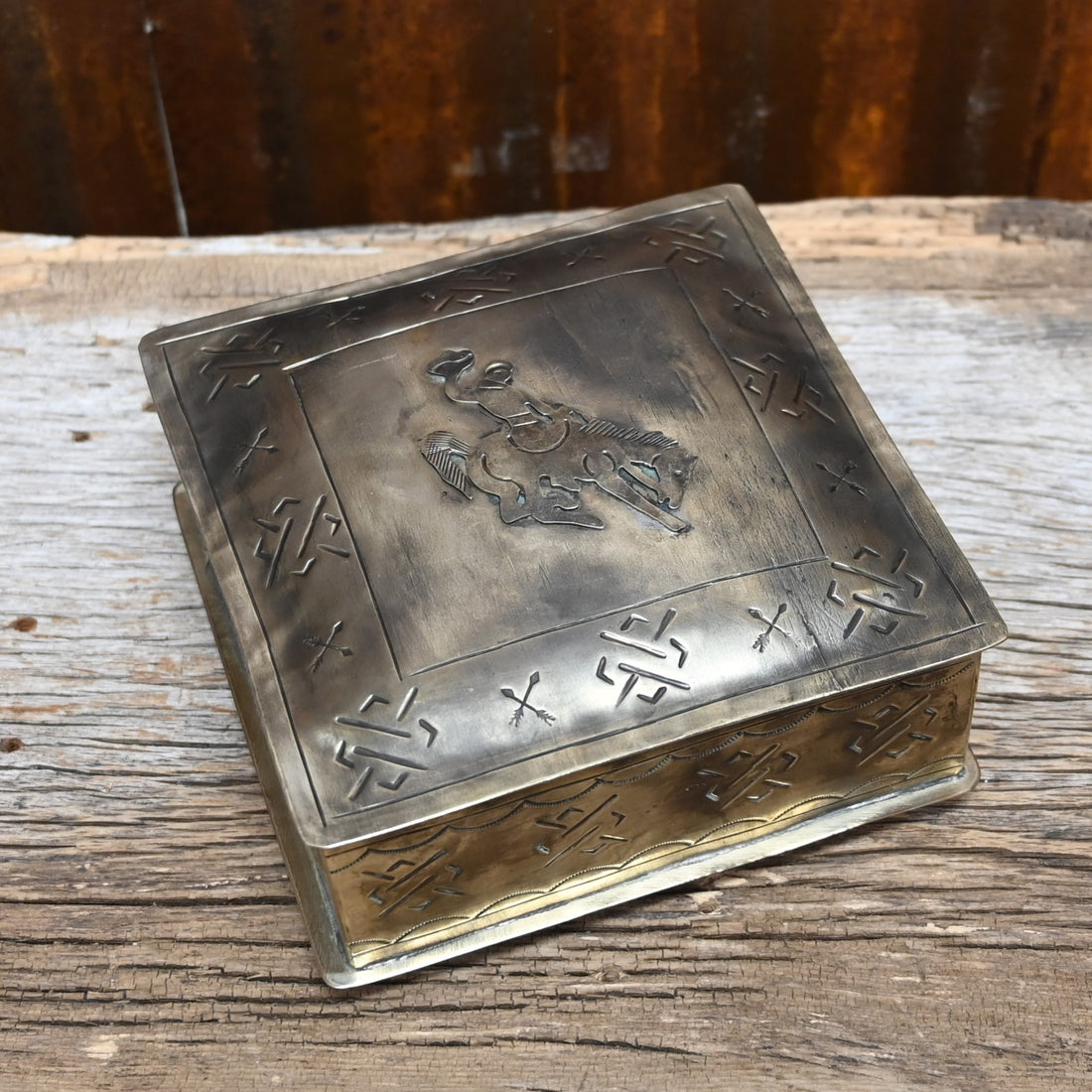 View of stamped silver box with bronco 