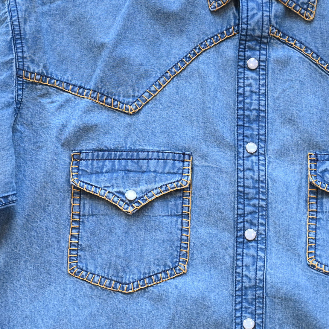 View of Rockmount men’s stonewashed denim Western shirt with blanket stitch detailing and snap front