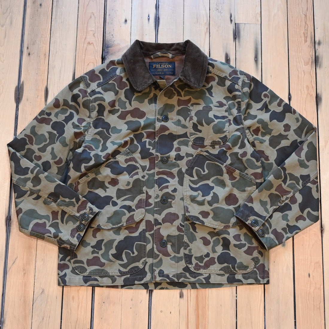 Filson Canvas Outfitter Jacket in shrub camo with dark brown corduroy collar and cargo-style pockets