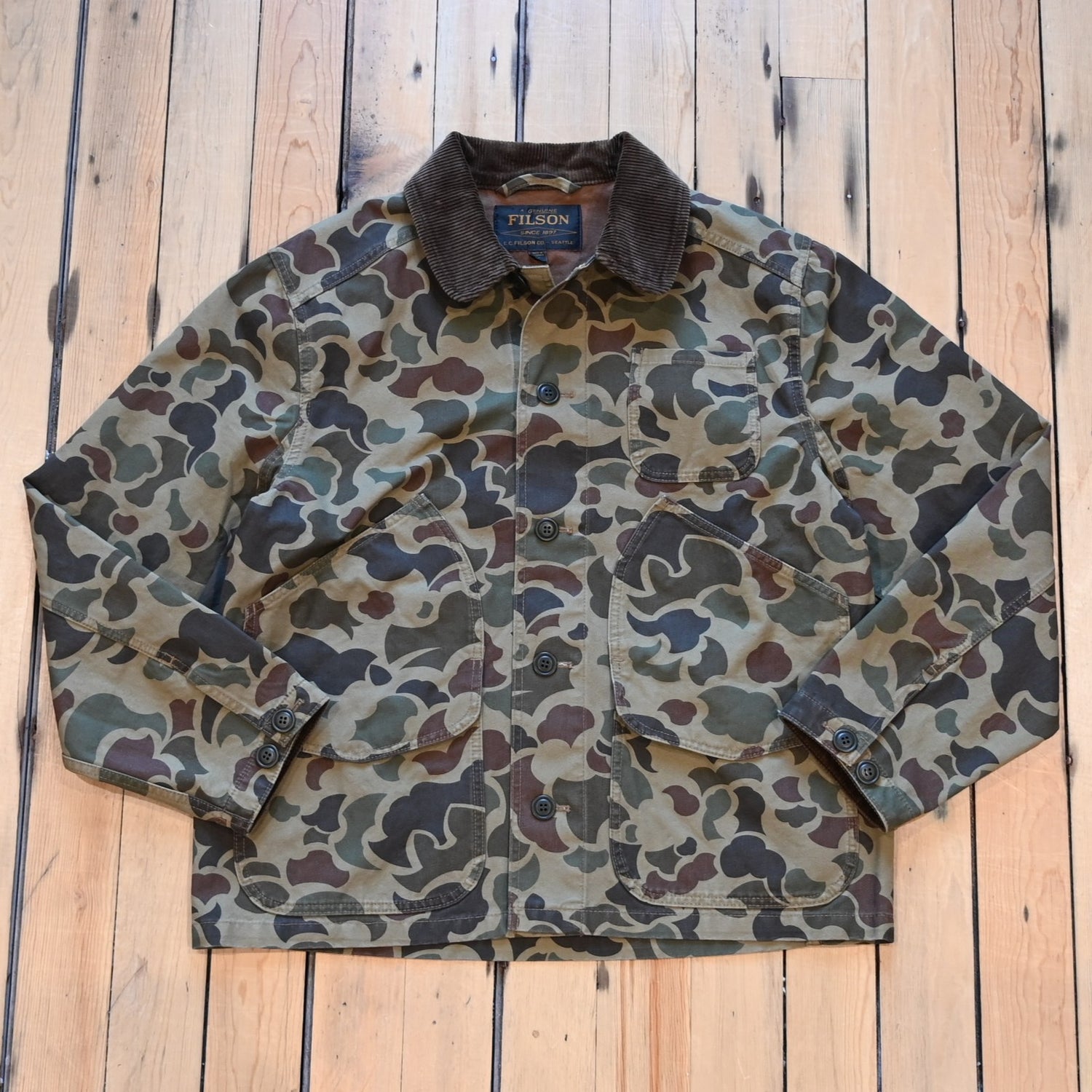 Filson Canvas Outfitter Jacket in shrub camo with dark brown corduroy collar and cargo-style pockets