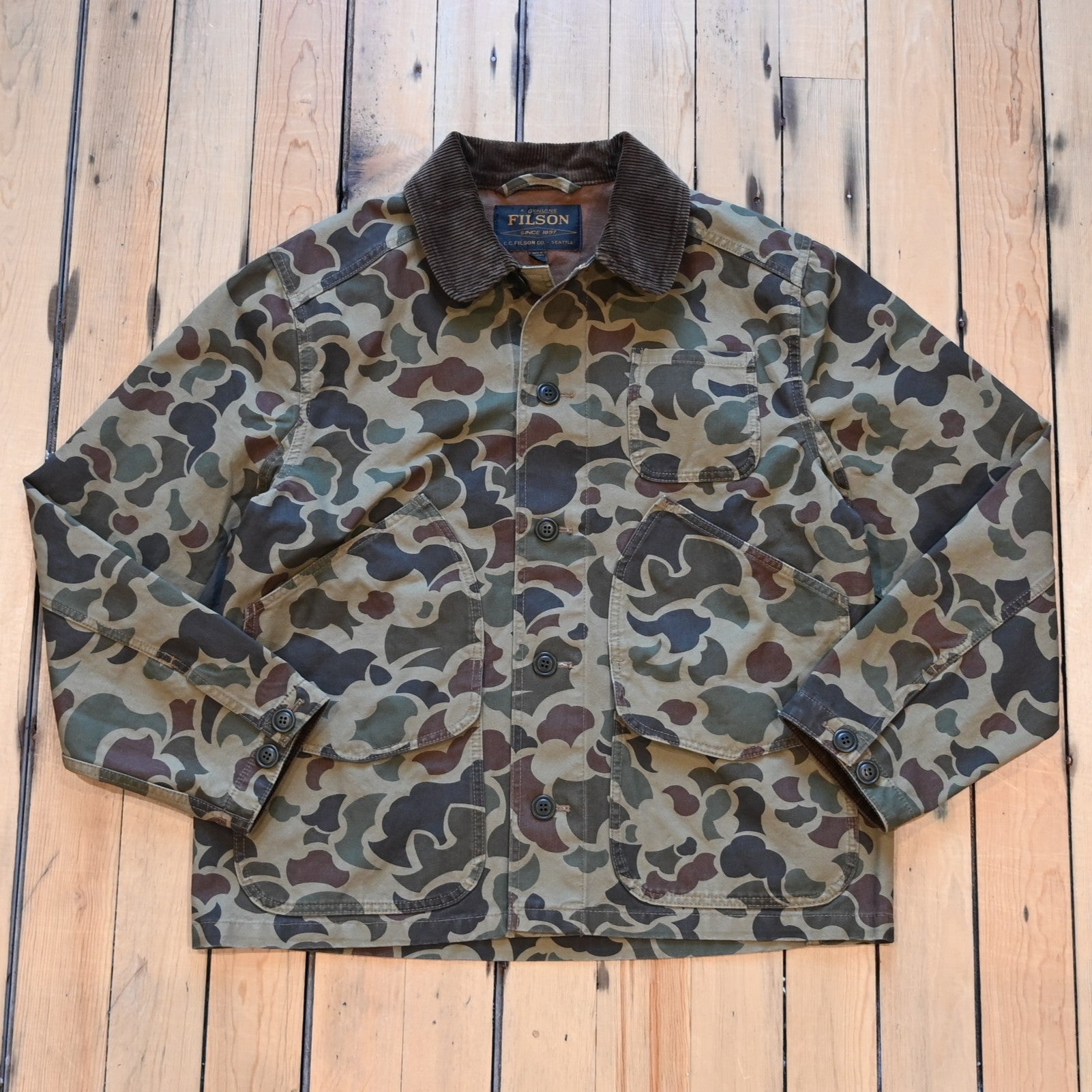 Filson Canvas Outfitter Jacket in shrub camo with dark brown corduroy collar and cargo-style pockets
