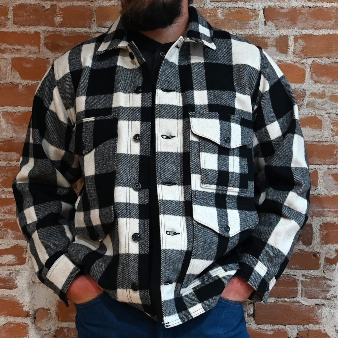 View of Filson Mackinaw Cruiser in Navy, Charcoal & Natural/Black Heritage Plaid featuring button-secure front closure, adjustable cuffs, and multiple pockets