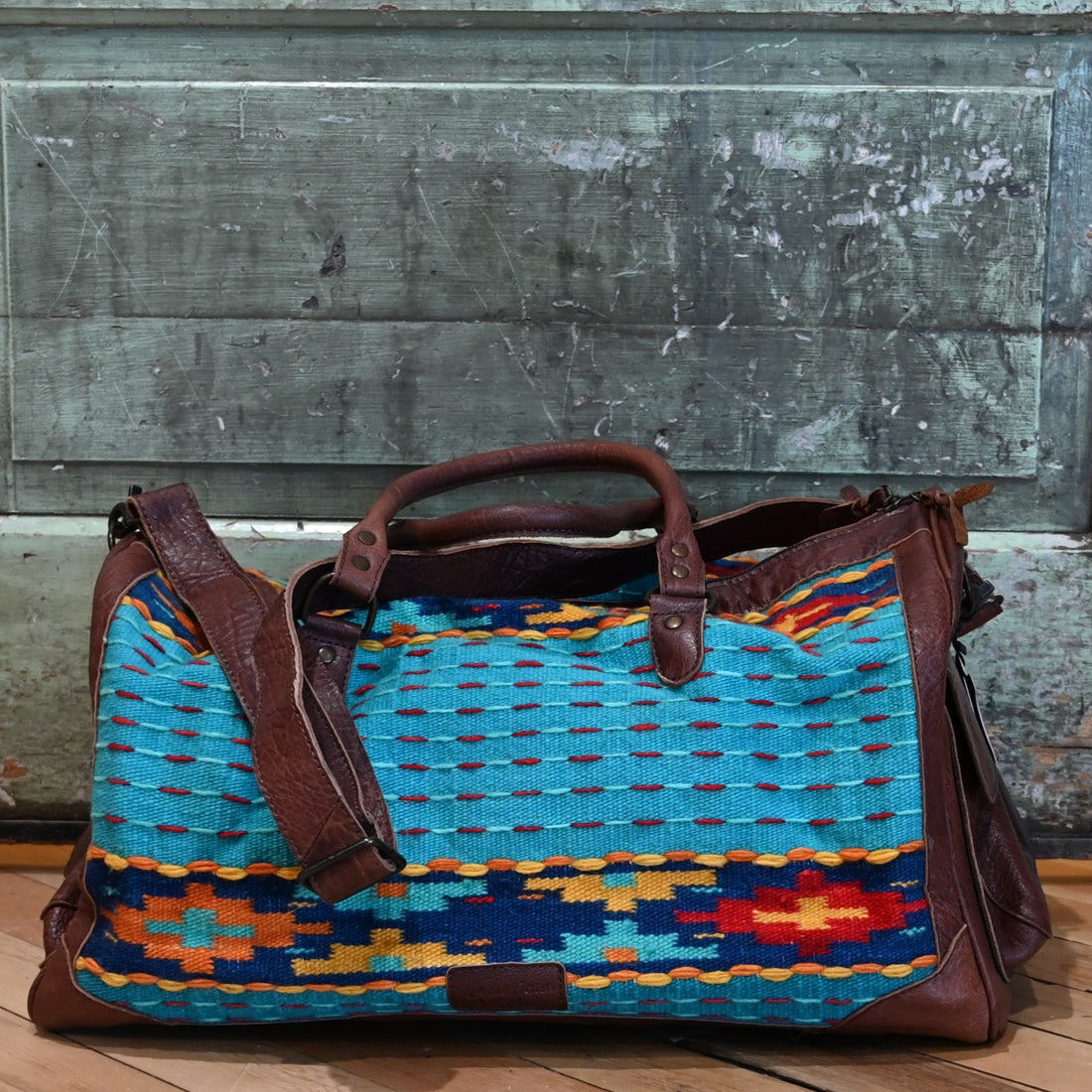 American Darling Blue Saddle Blanket Duffel Bag with genuine leather trim and multicolor Southwestern pattern