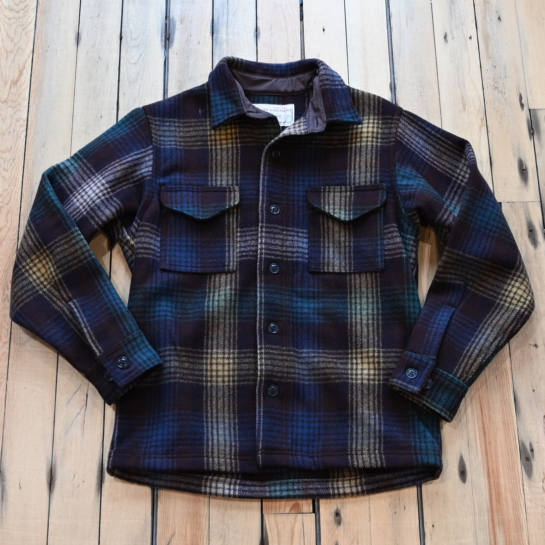View of Filson Mackinaw Wool Jac-Shirt in Black Coffee Multi Plaid and Red/Black Ombre Plaid featuring button-front closure, adjustable cuffs, and hidden button-secured pockets
