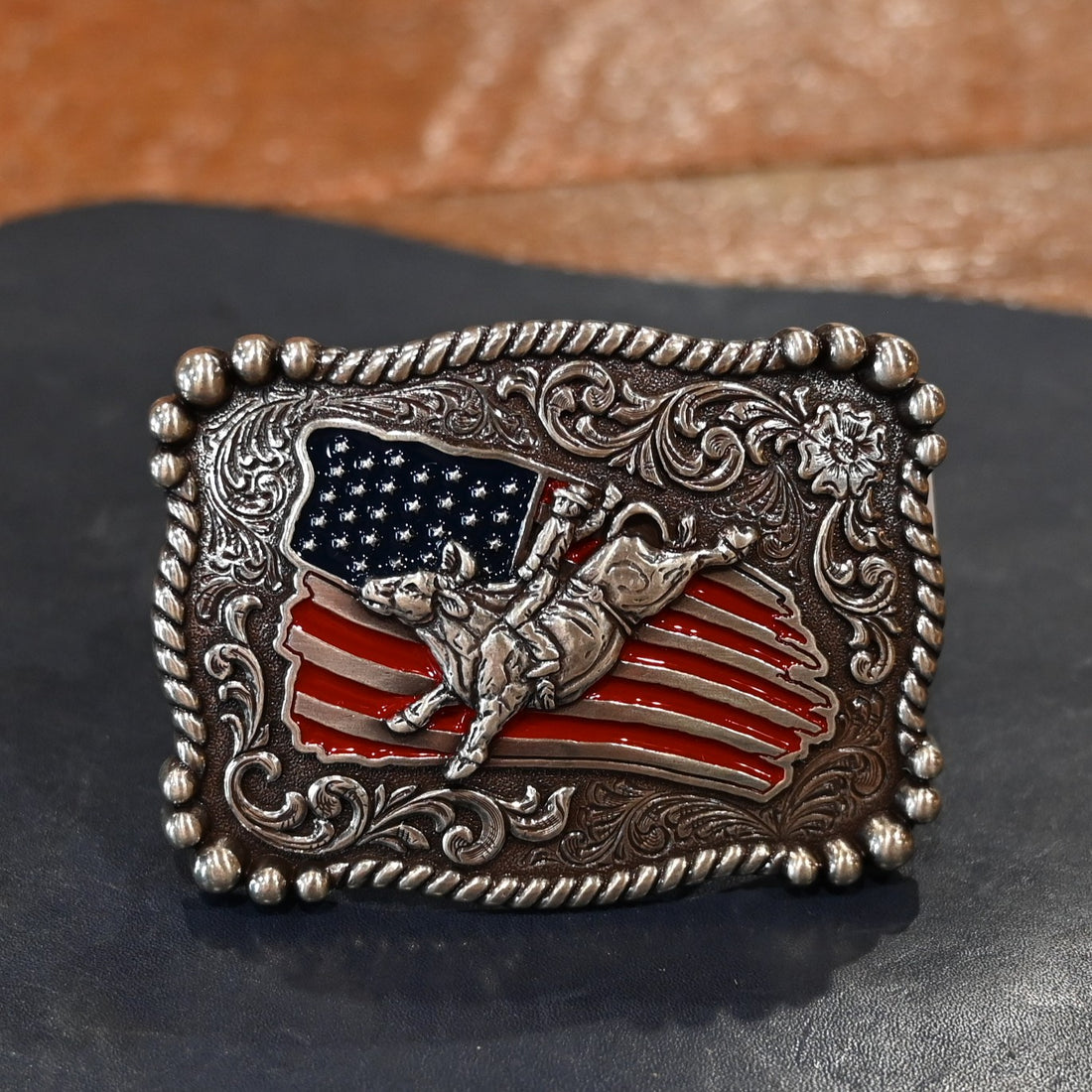 Nocona youth rectangle bull rider and USA flag belt buckle with rope edge border