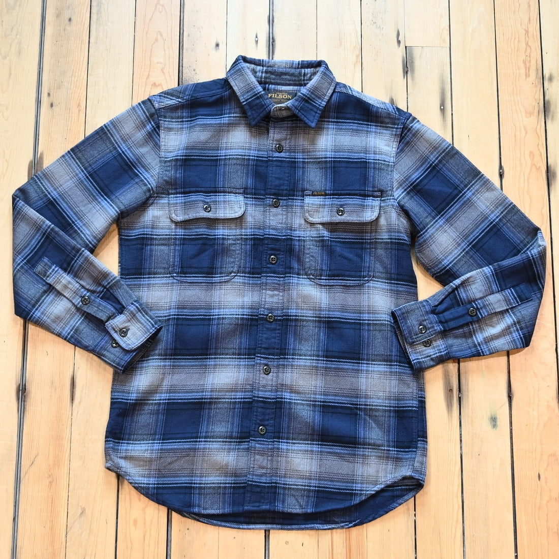 Filson Vintage Flannel Work Shirt in light blue and navy plaid with button-front closure and chest pockets