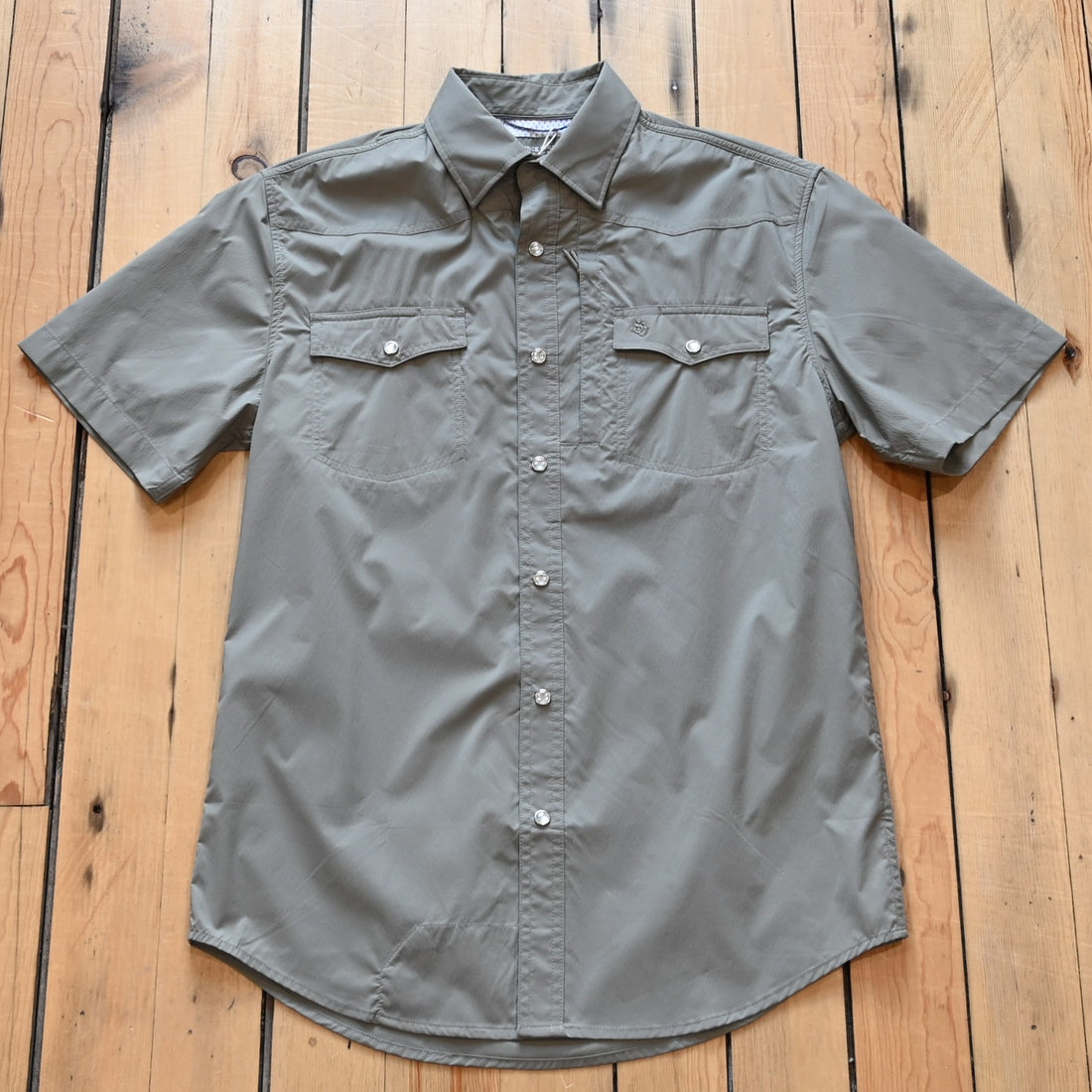 View of Schaefer men’s sage short‑sleeve RangeTek Western snap shirt with mesh vent and security pocket