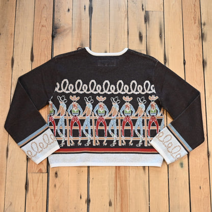 View of Long Tall Texan cropped sweater in bronco brown with embroidered cowboy characters, contrasting cuffs, and rope detail