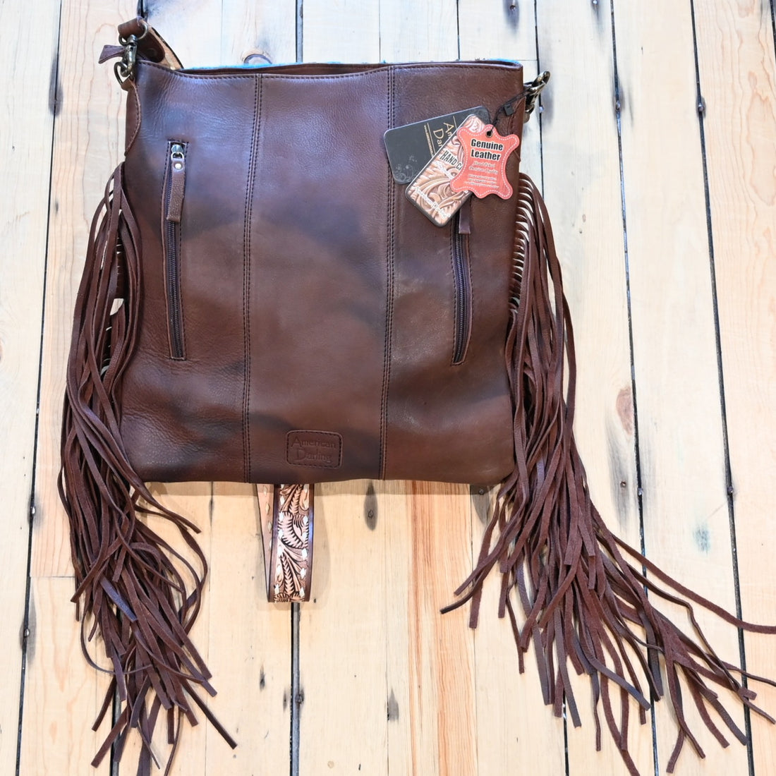 American Darling vintage saddle blanket conceal carry bag in burgundy, rust, blue, and brown with brown leather fringe on the sides