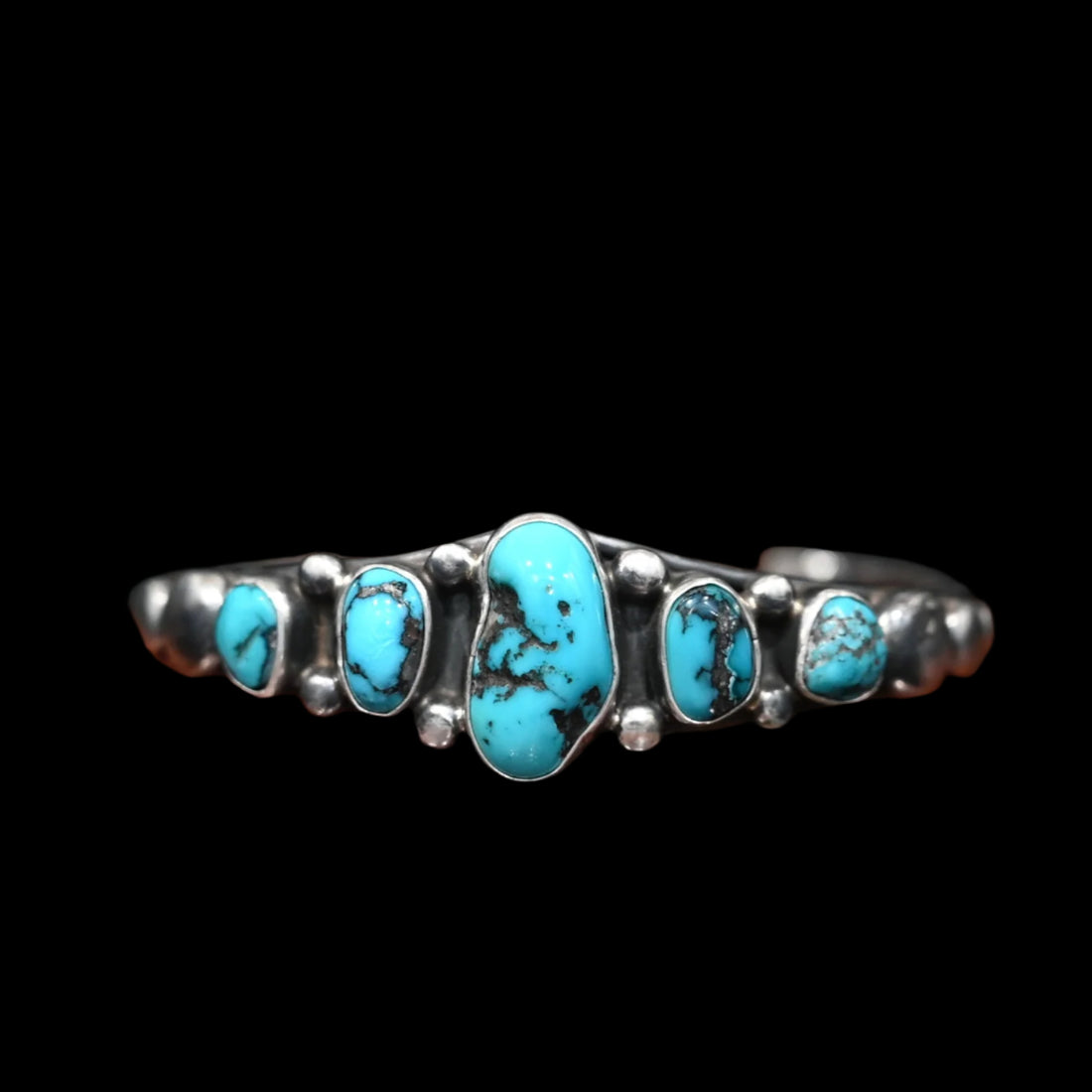 View of Sunwest Silver Kingman Turquoise Cuff featuring five Kingman turquoise stones, with the largest at the center, set in sterling silver